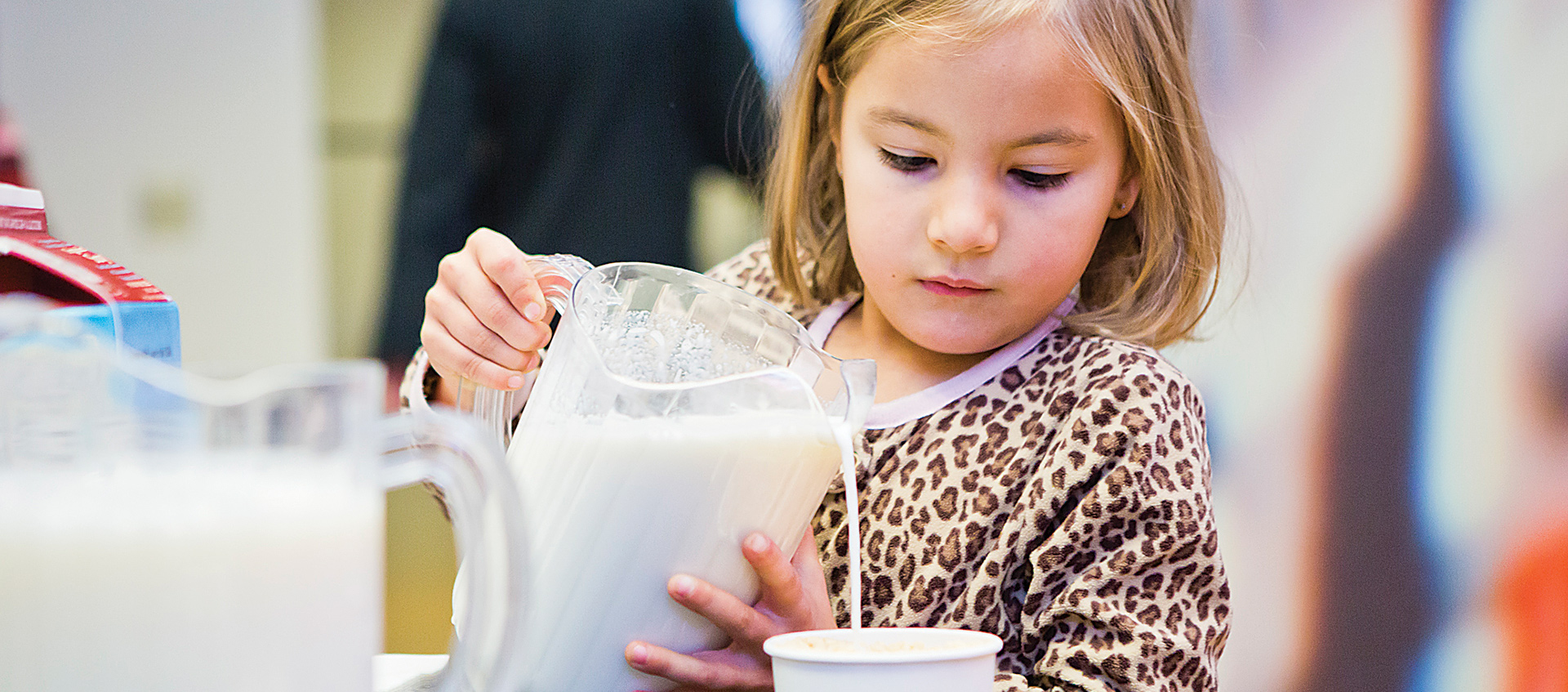 Child pouring milk