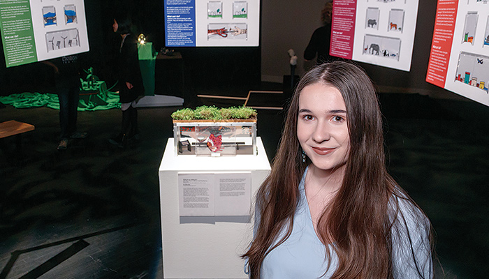 Art + Ecology student poses with her project