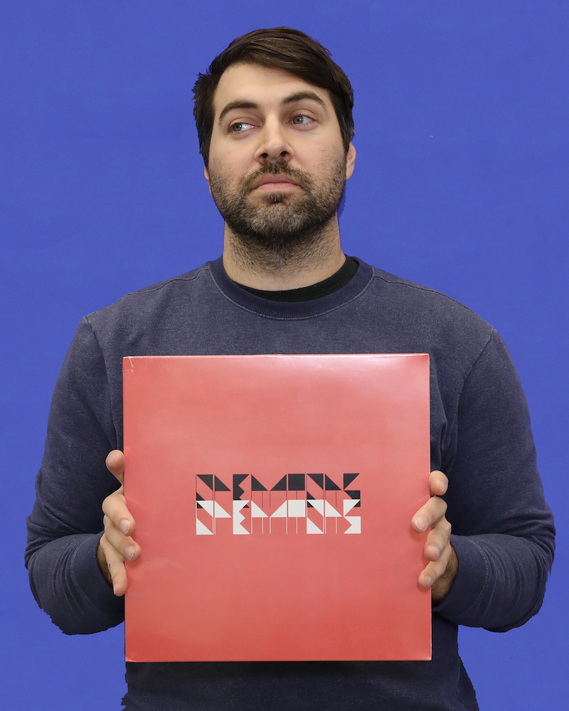Wexner Center for the Arts Preparator James-David Mericle with an LP album by the Operators for the 2018 holiday gift guide