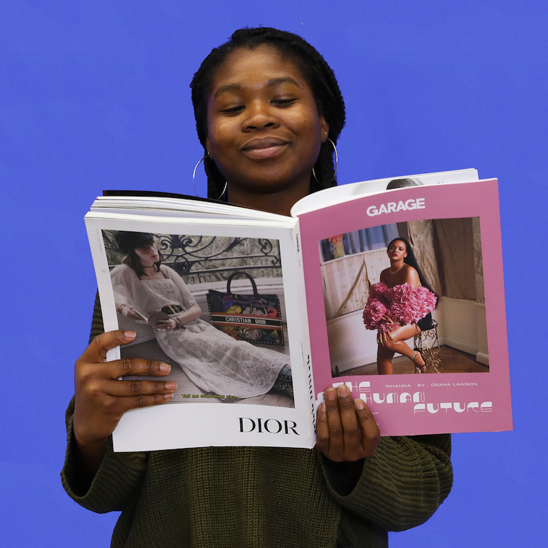 Wexner Center for the Arts Customer Service Student Assistant Seyi Adeyemi with a copy of the magazine Garage for the 2018 holiday gift guide