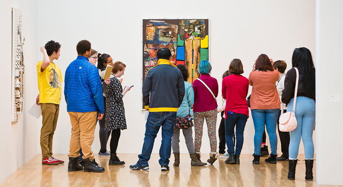 A group of people tour the gallery.