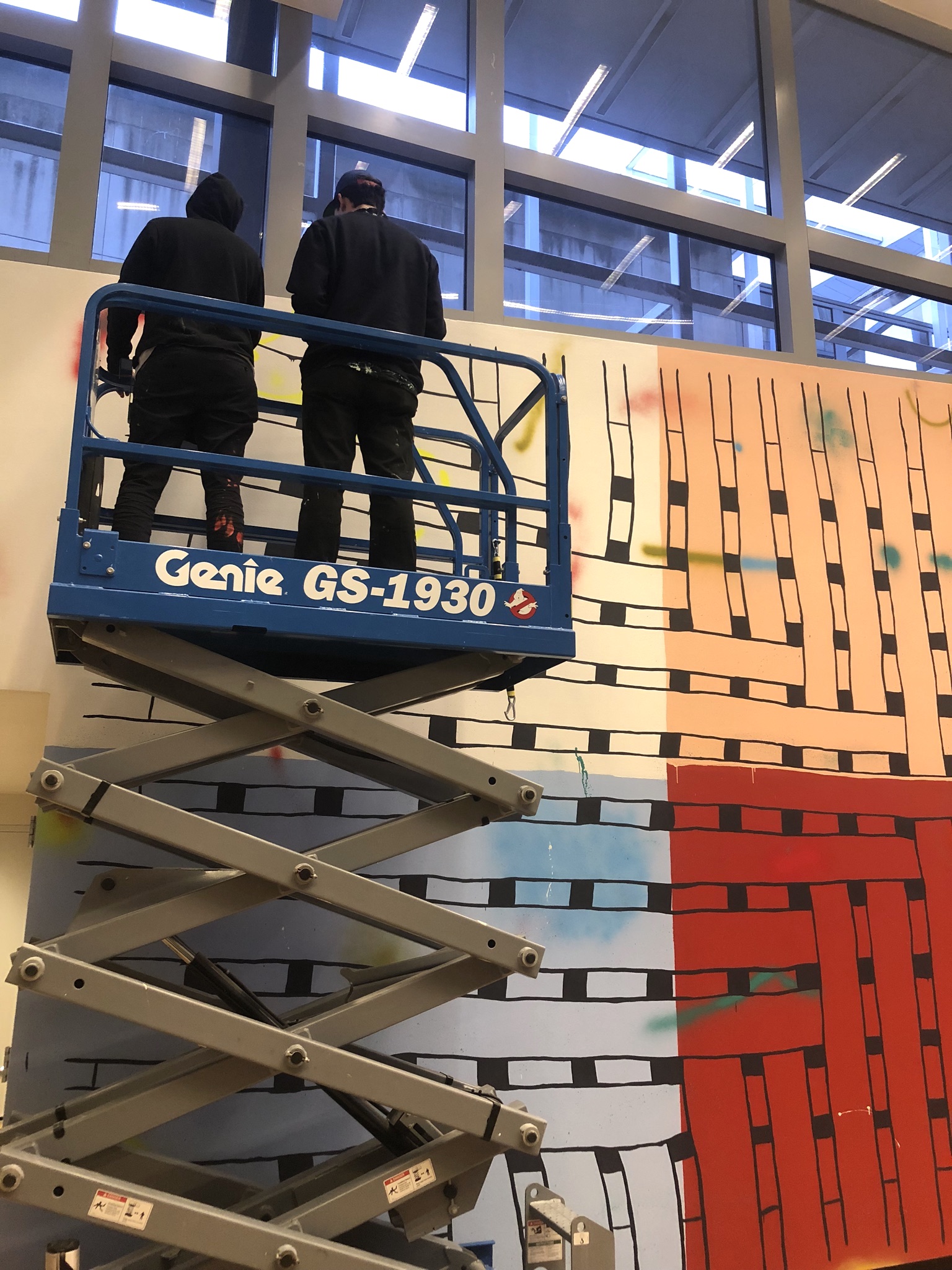 Artists Alicia McCarthy and Oliver Hawk Holden work on the site-specific mural No Straight Lines at the Wexner Center for the Arts at The Ohio State University