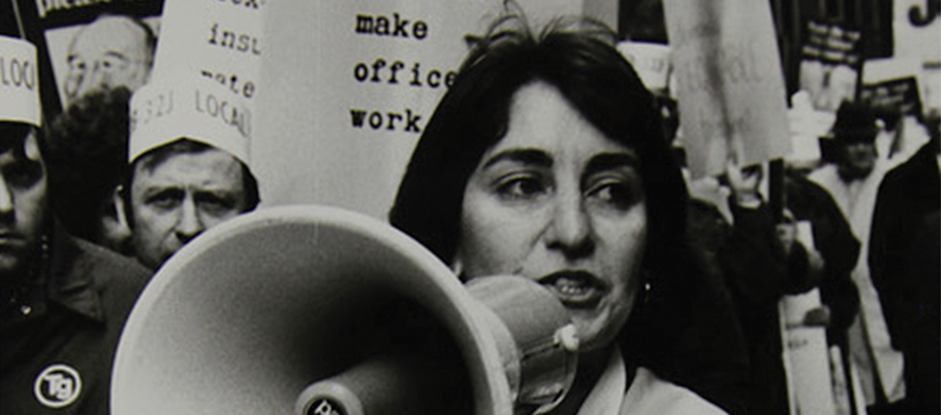 Image of woman with bullhorn from 9to5: The Story of a Movement