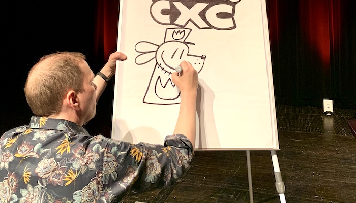 Cartoonist Dav Pilkey draws a character from his Captain Underpants book series on the stage of Mershon Auditorium during the 2020 Cartoon Crossroads Columbus
