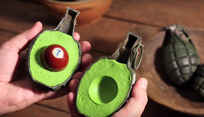 An image of a hand grenade cut in half, filled with green clay and a pool ball to mimic the appearance of a sliced avocado in the stop-motion animated short Fresh Guacamole by PES