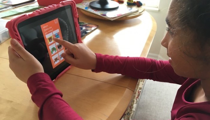 A young girl participates in a remote class from the Cleveland Play House via tablet
