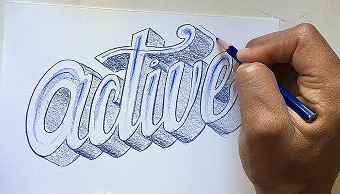 The hand of artist and author Robert Liu-Trujillo drawing a decorative treatment of the word "active"
